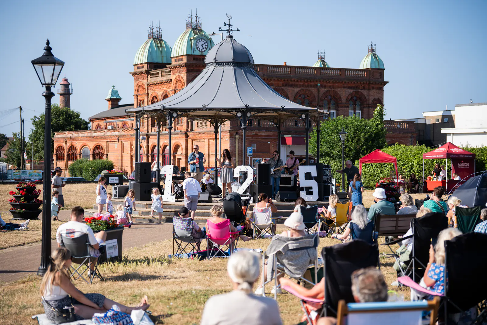 A large audience watching live music at the Pavilion’s bandstand birthday celebration