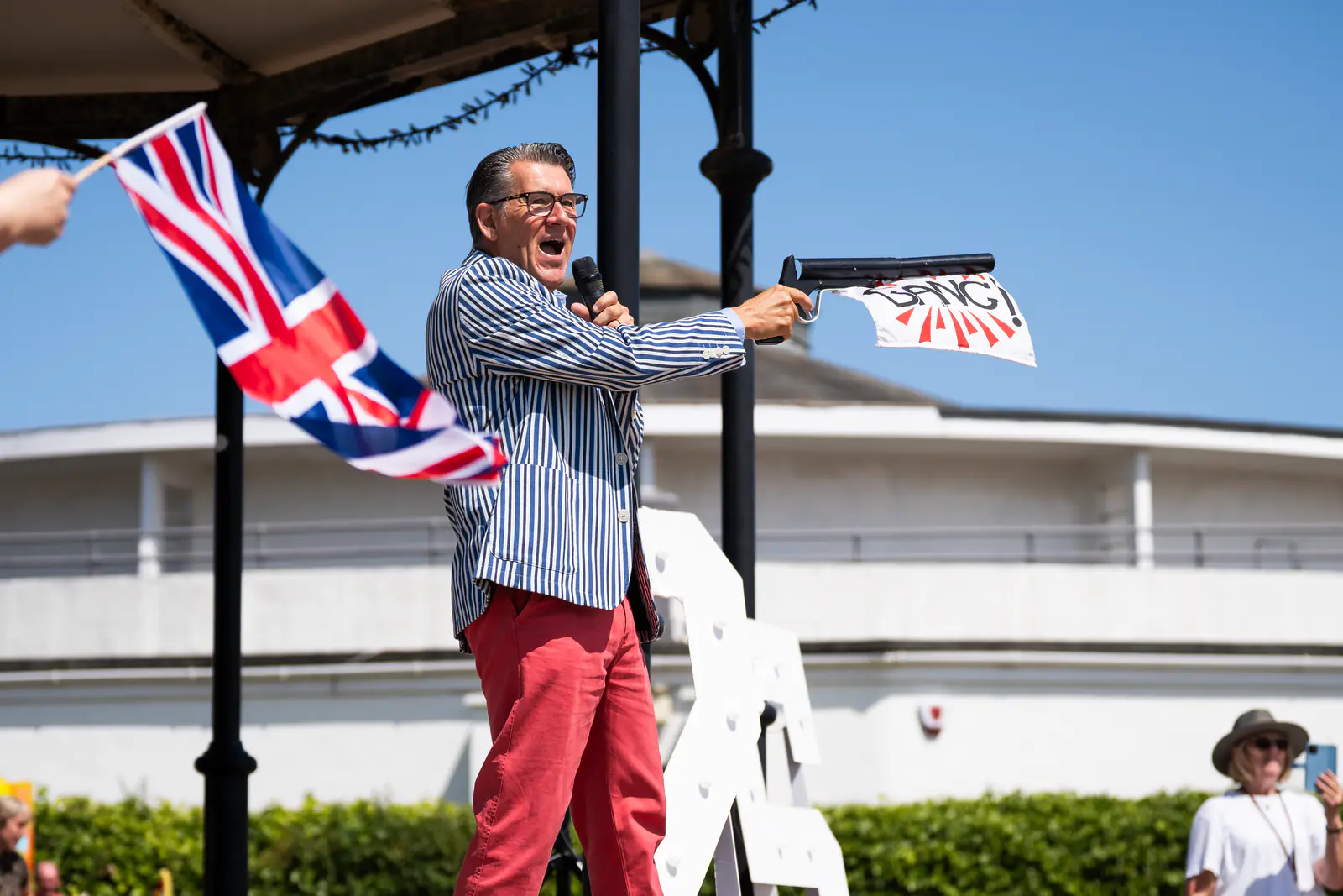 The birthday celebration compère firing a theatrical starting pistol