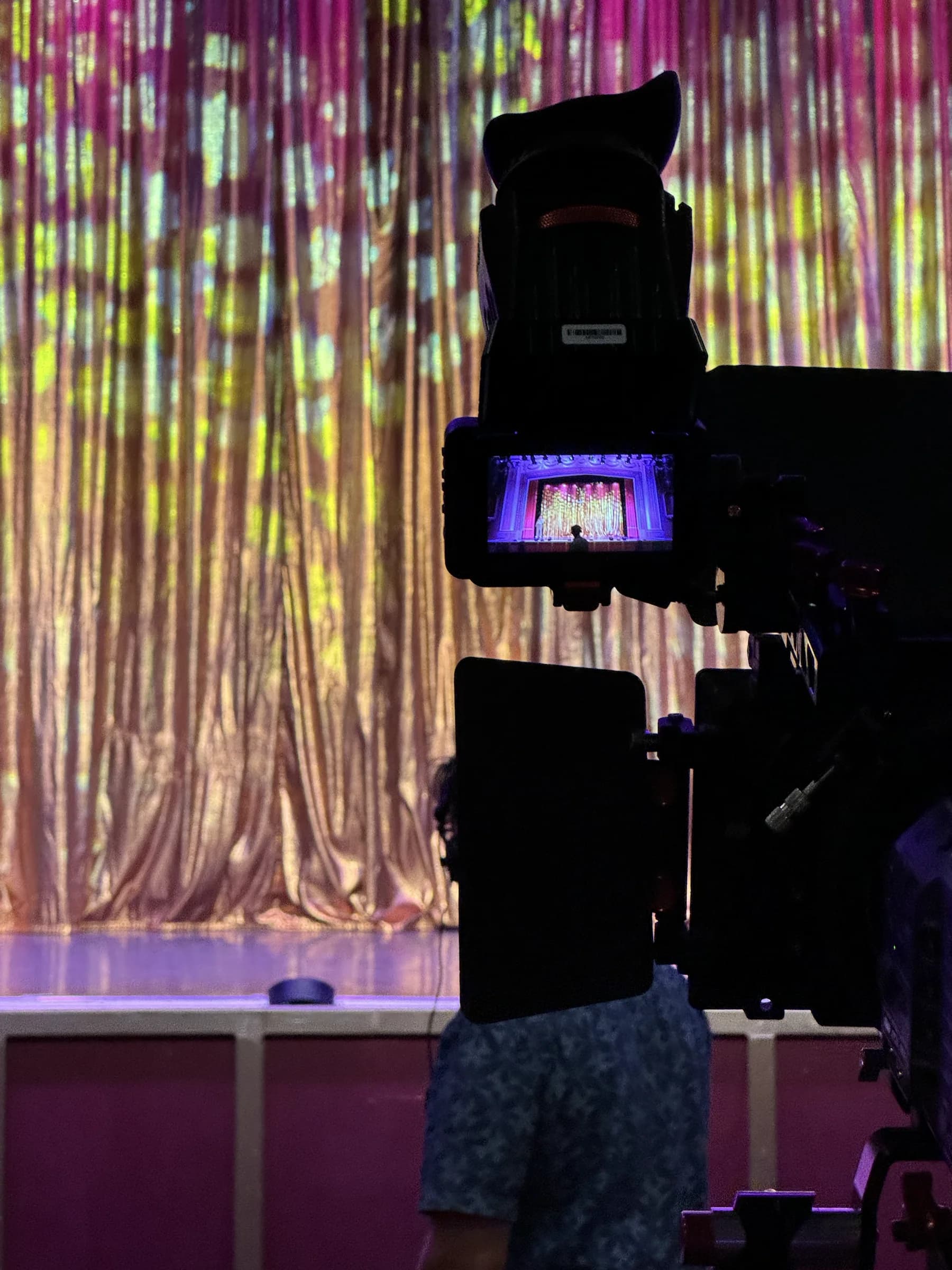 A close view of a broadcast camera monitor showing the stage