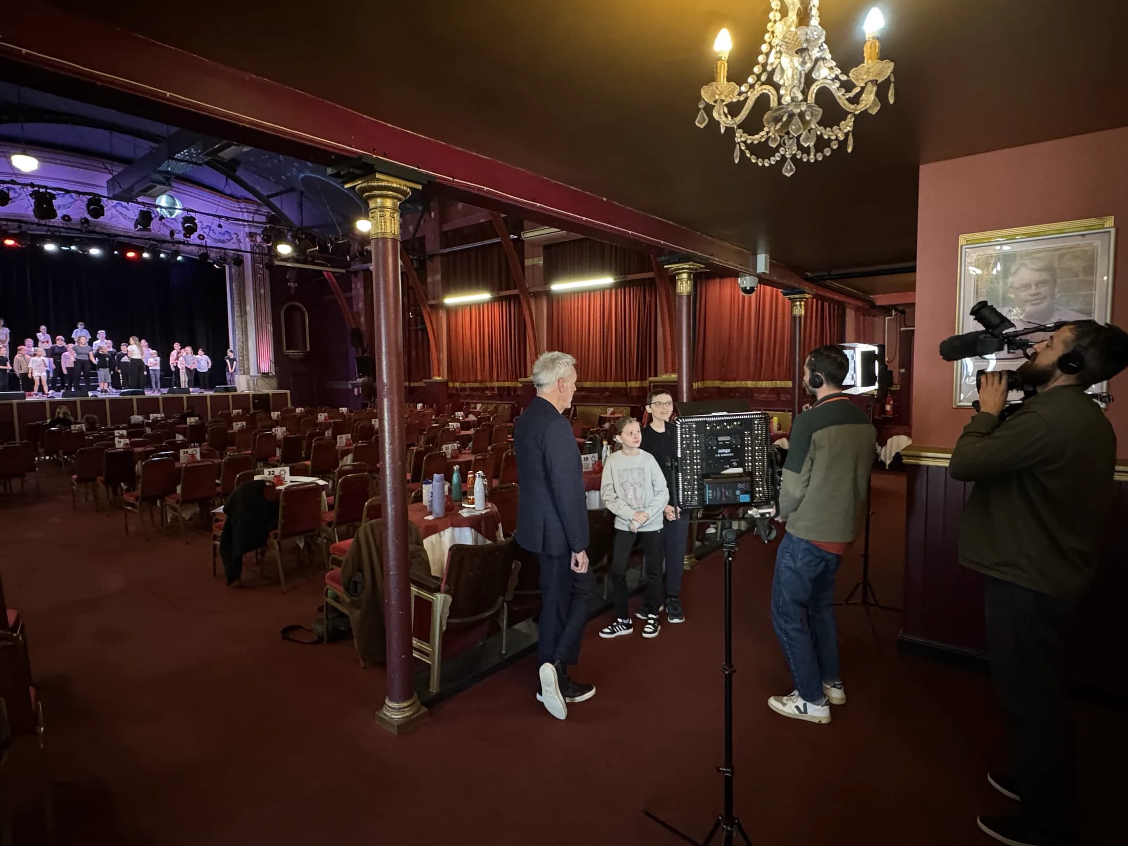 Brian Conley and young performers being filmed in the Pavilion auditorium