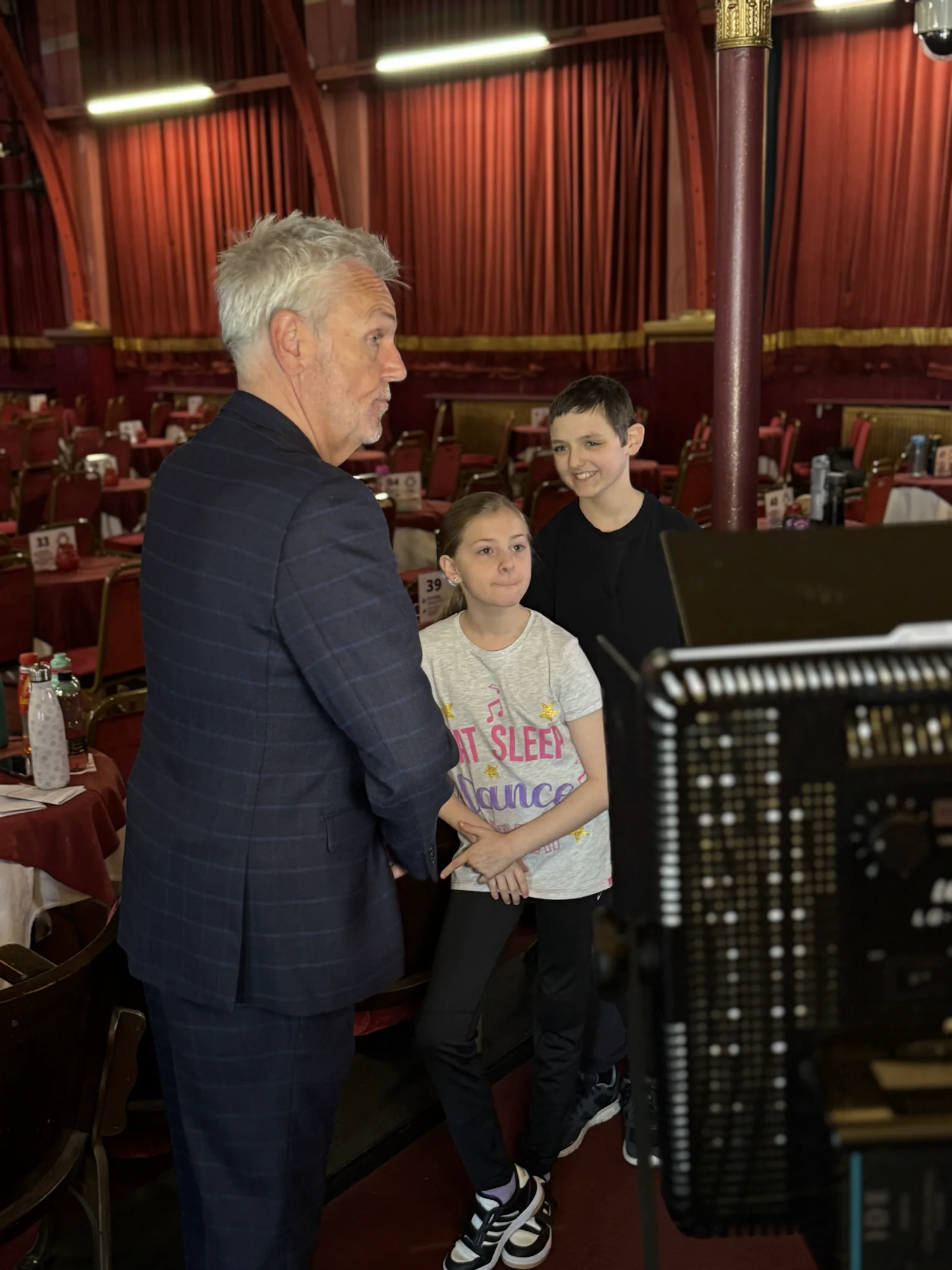 Brian Conley talking with two young Pavilion performers during filming