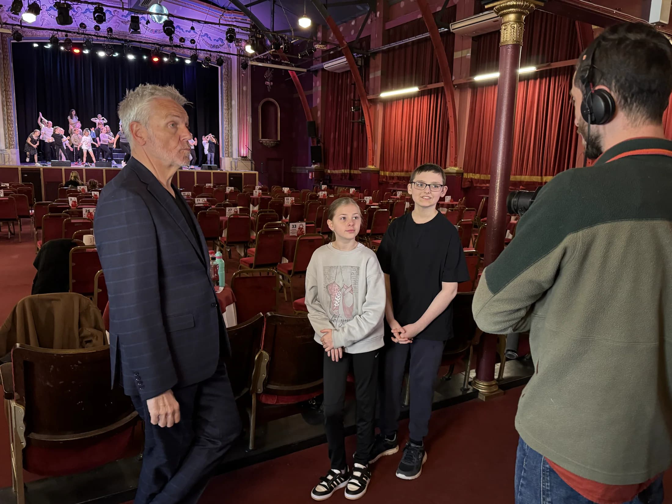 Brian Conley talking to two young Pavilion performers on camera
