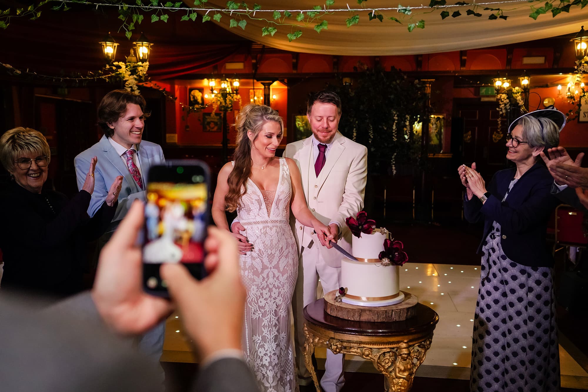 A wedding cake being cut at the Pavilion