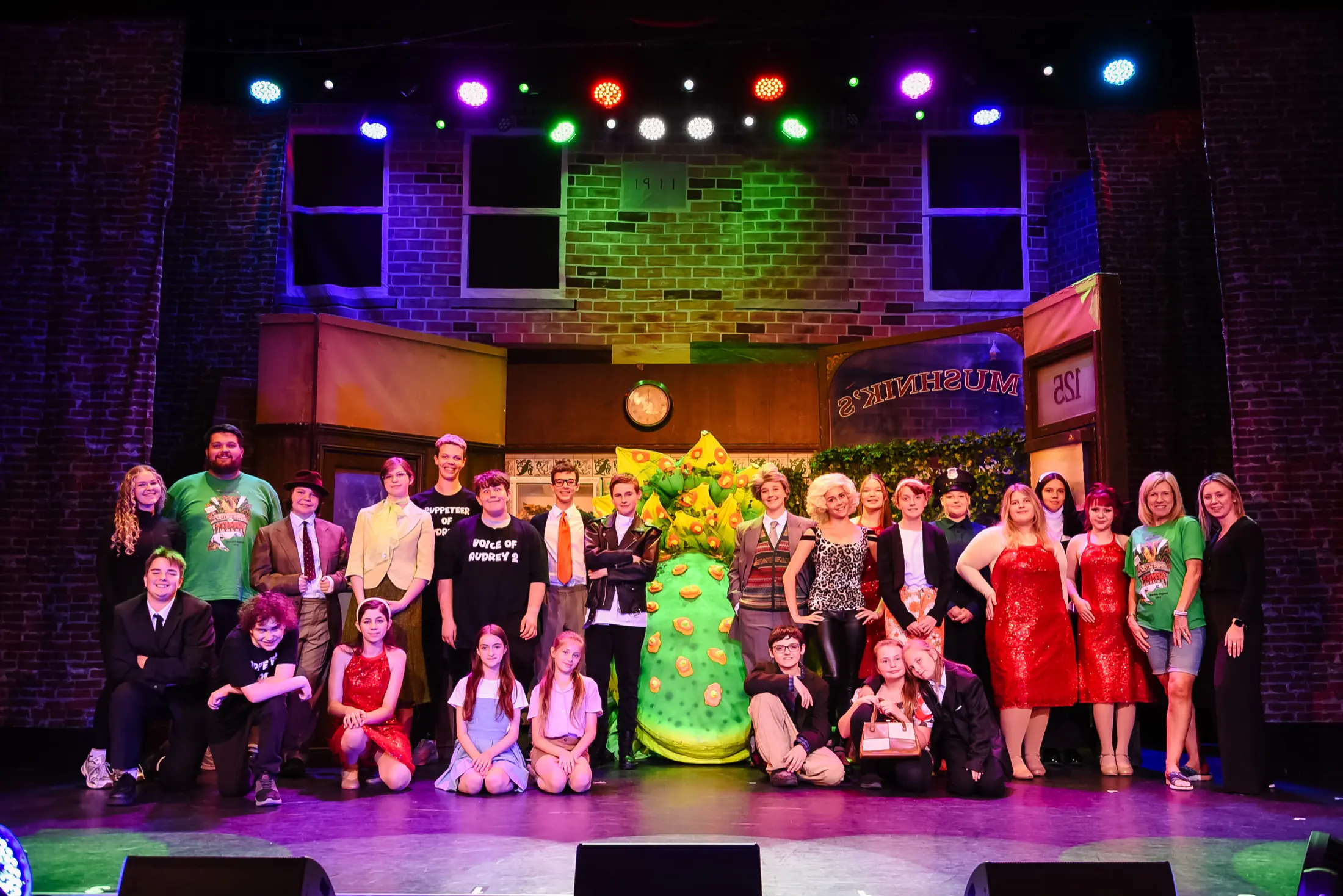 Pavilion Players Stage School cast and creative team on the Little Shop of Horrors set