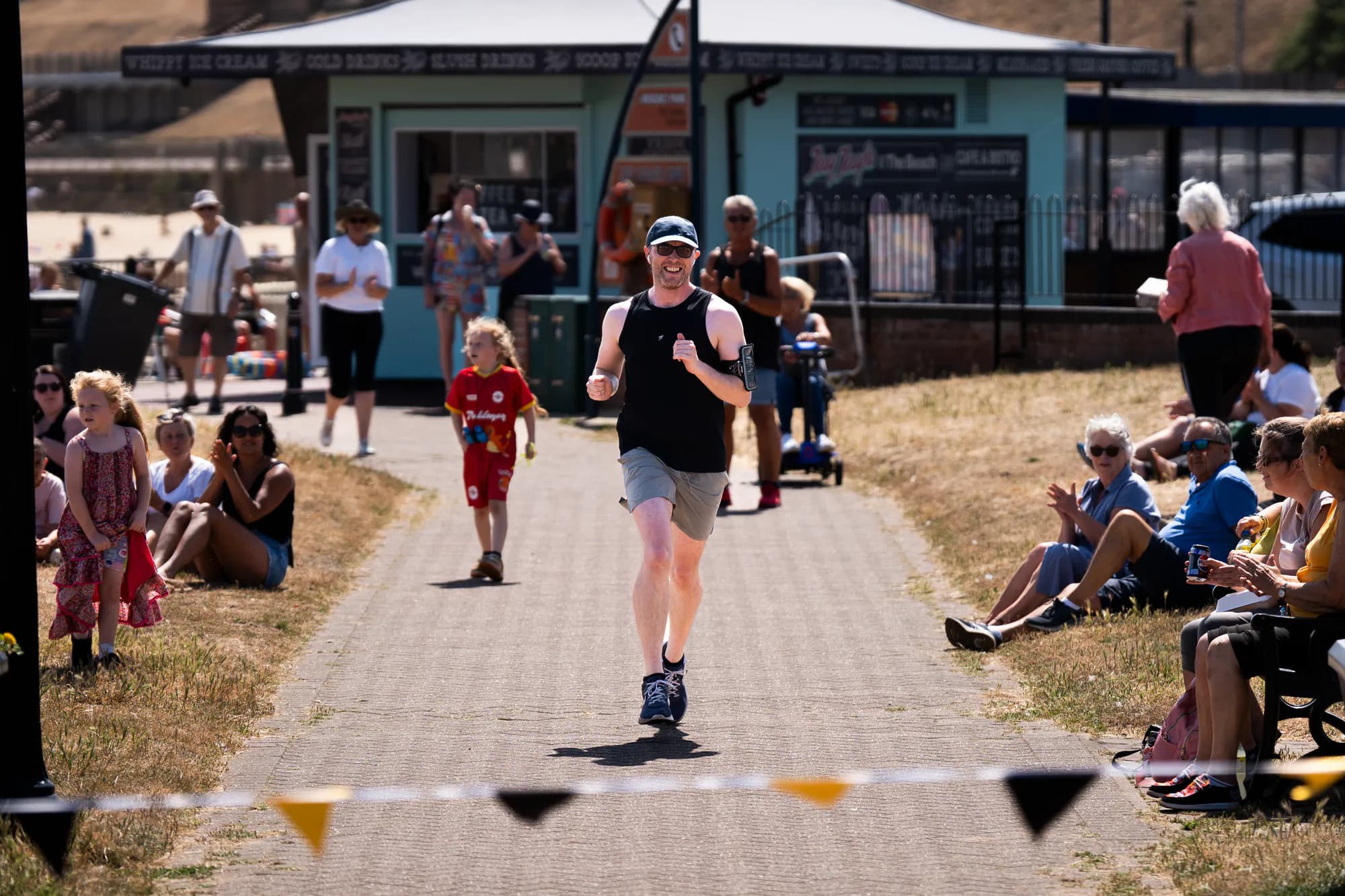 Luke running his 125K fundraising challenge past supporters on Gorleston seafront