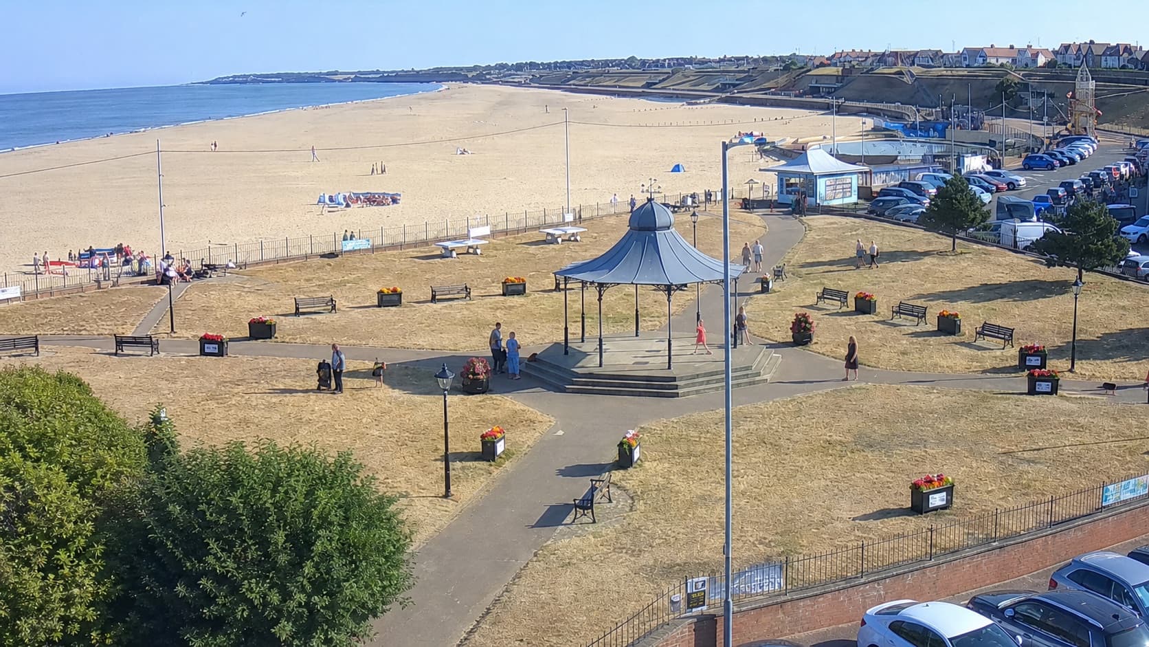 Sunny summer view across Gorleston beach, Pier Gardens and the Pavilion Bandstand
